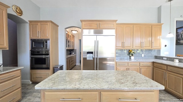 kitchen with tasteful backsplash, built in appliances, and light brown cabinetry