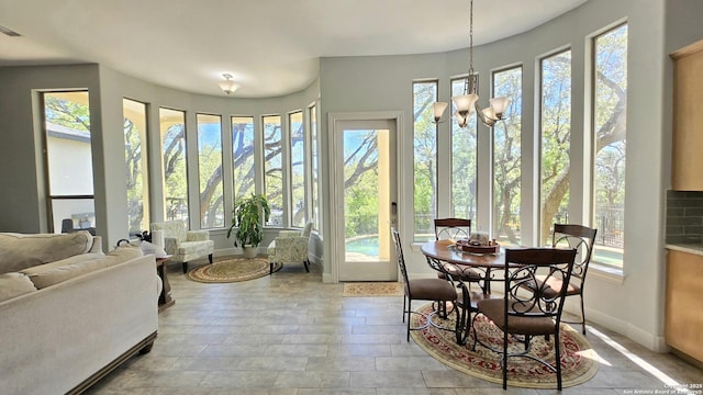 interior space featuring an inviting chandelier, baseboards, and visible vents