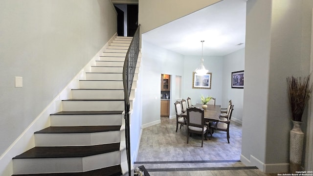 staircase featuring baseboards and wood finished floors