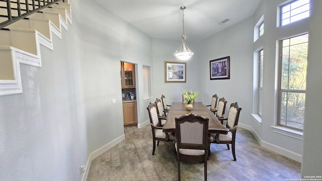 dining space featuring light wood finished floors, baseboards, and visible vents
