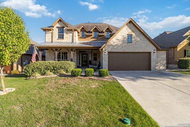 500 Pecan Farms, New Braunfels, TX 78130 - traditional-style house with a front yard, an attached garage, stone siding, covered porch, and concrete driveway