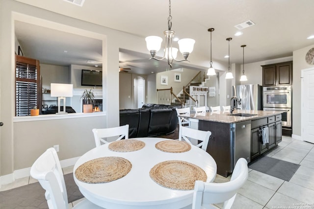 500 Pecan Farms, New Braunfels, TX 78130 - dining space featuring baseboards, stairway, light tile patterned floors, visible vents, and ceiling fan with notable chandelier