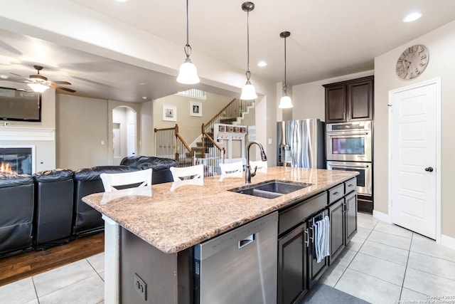 500 Pecan Farms, New Braunfels, TX 78130 - kitchen featuring a sink, open floor plan, appliances with stainless steel finishes, a ceiling fan, and light tile patterned flooring