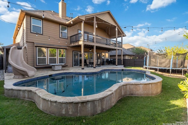 500 Pecan Farms, New Braunfels, TX 78130 - rear view of property with a yard, a trampoline, a chimney, fence, and a patio