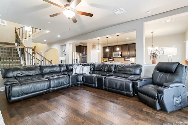 500 Pecan Farms, New Braunfels, TX 78130 - living room with ceiling fan with notable chandelier, dark wood finished floors, visible vents, and stairs