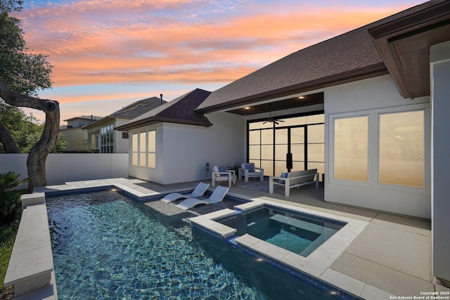 view of pool featuring a patio area, a ceiling fan, fence, an outdoor hangout area, and an in ground hot tub