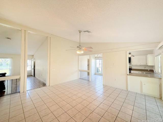 7401 Oak Marsh, Live Oak, TX 78233 - interior space with light tile patterned flooring, ceiling fan, lofted ceiling, and plenty of natural light