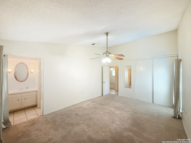 7401 Oak Marsh, Live Oak, TX 78233 - unfurnished bedroom with a closet, ceiling fan, a textured ceiling, ensuite bath, and light colored carpet