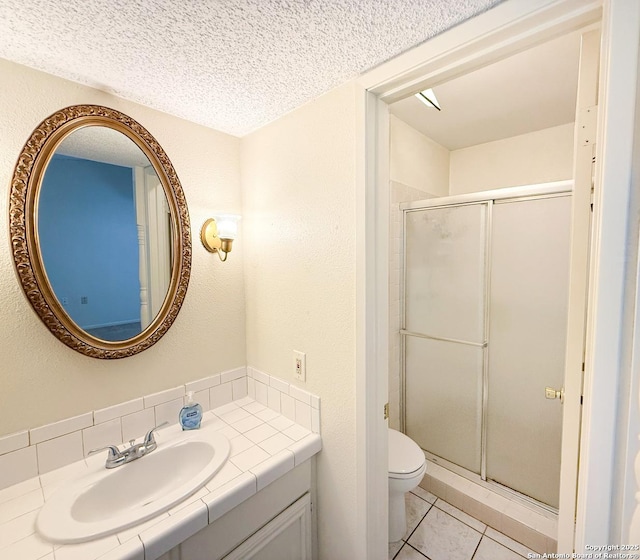 7401 Oak Marsh, Live Oak, TX 78233 - bathroom featuring a textured ceiling, vanity, tile patterned flooring, toilet, and a stall shower