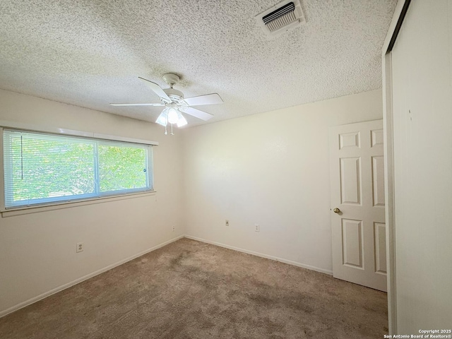 7401 Oak Marsh, Live Oak, TX 78233 - carpeted empty room with baseboards, visible vents, a textured ceiling, and a ceiling fan