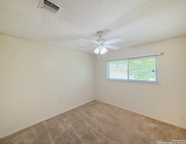 7401 Oak Marsh, Live Oak, TX 78233 - spare room featuring visible vents, baseboards, ceiling fan, a textured ceiling, and light carpet