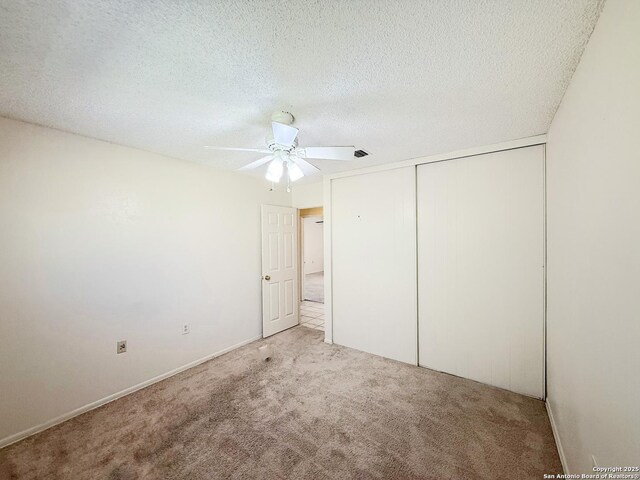 7401 Oak Marsh, Live Oak, TX 78233 - unfurnished bedroom with a textured ceiling, a closet, a ceiling fan, and carpet floors