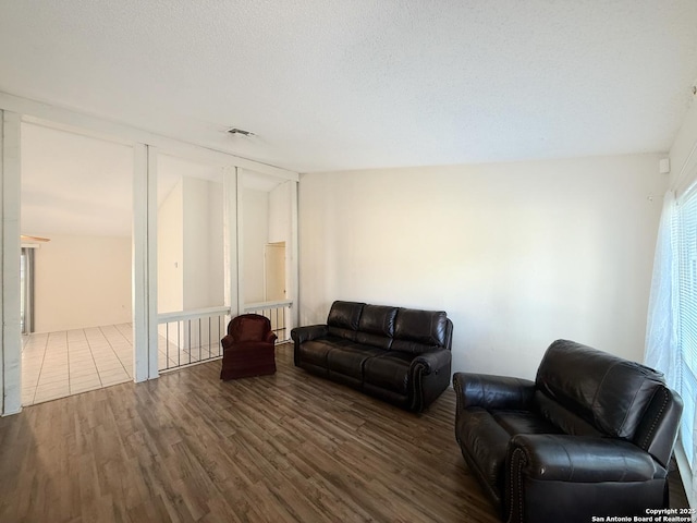 7401 Oak Marsh, Live Oak, TX 78233 - living area featuring a textured ceiling, wood finished floors, and visible vents