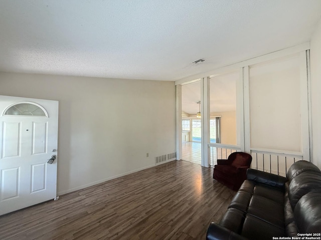 7401 Oak Marsh, Live Oak, TX 78233 - living room featuring visible vents, baseboards, wood finished floors, and a textured ceiling