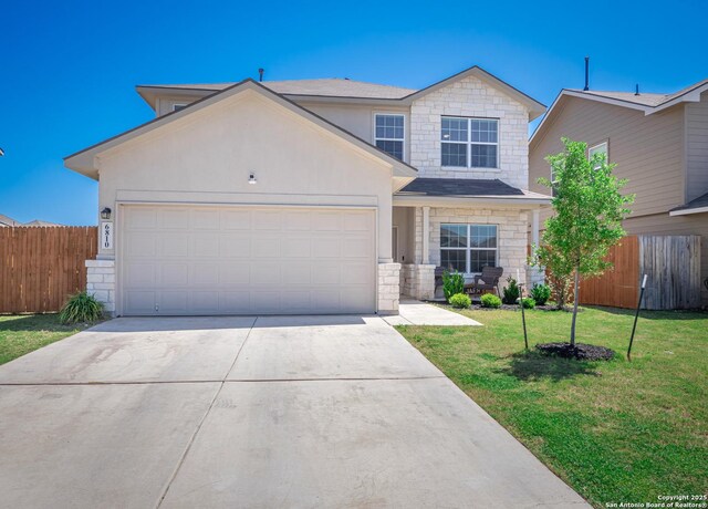 6810 Courante Waltz, San Antonio, TX 78252 - view of front facade with a front yard, driveway, stone siding, and fence