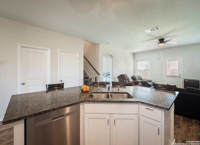 6810 Courante Waltz, San Antonio, TX 78252 - kitchen featuring a sink, open floor plan, a ceiling fan, dark stone counters, and stainless steel dishwasher