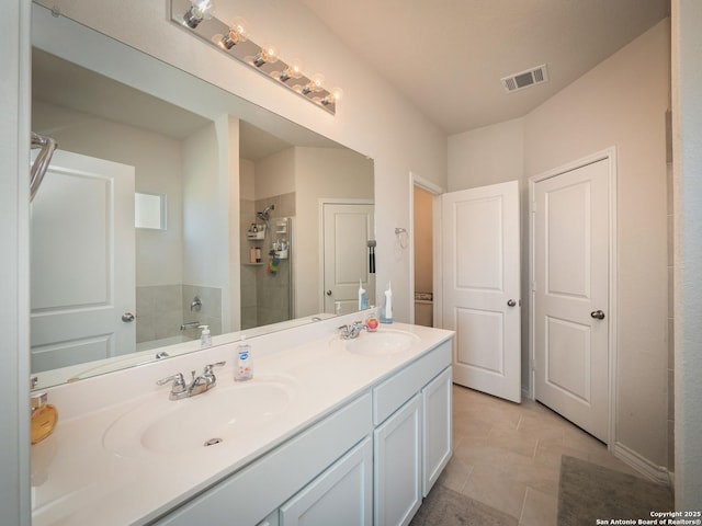 6810 Courante Waltz, San Antonio, TX 78252 - bathroom featuring a shower stall, double vanity, visible vents, and a sink