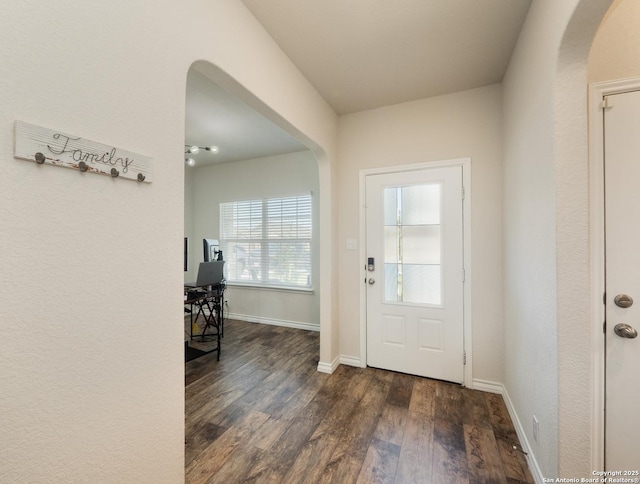 6810 Courante Waltz, San Antonio, TX 78252 - entrance foyer with arched walkways, baseboards, and dark wood-style floors