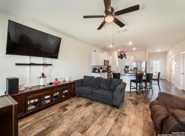 6810 Courante Waltz, San Antonio, TX 78252 - living room with ceiling fan, dark wood finished floors, and visible vents