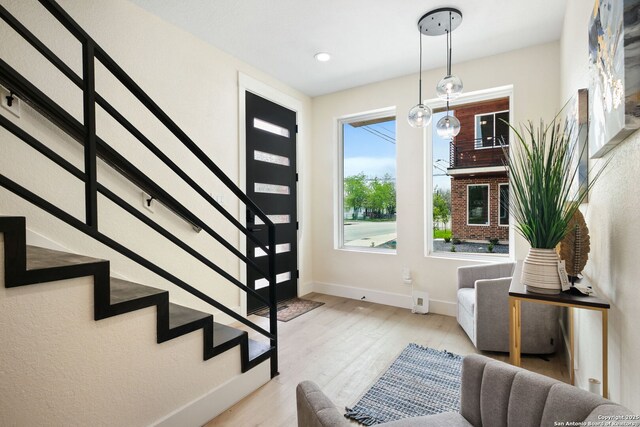 1019 S Hackberry, San Antonio, TX 78210 - entrance foyer with baseboards, wood finished floors, and stairs