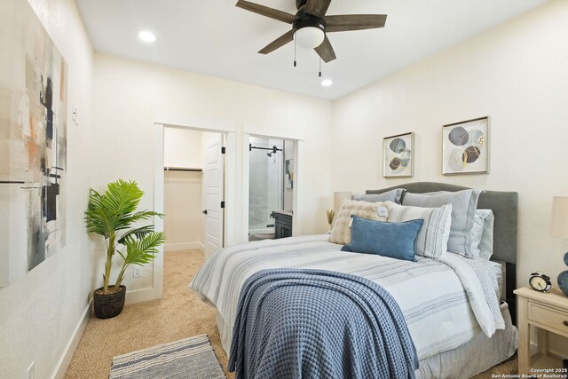 1019 S Hackberry, San Antonio, TX 78210 - bedroom featuring a walk in closet, ceiling fan, baseboards, and carpet floors