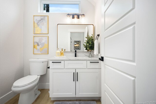1019 S Hackberry, San Antonio, TX 78210 - bathroom with toilet, vanity, wood finished floors, and baseboards
