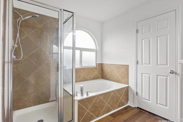 9311 Longmire, San Antonio, TX 78245 - bathroom featuring a shower stall, a garden tub, and wood finished floors