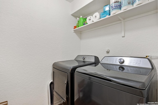 9311 Longmire, San Antonio, TX 78245 - washroom featuring separate washer and dryer and a textured wall