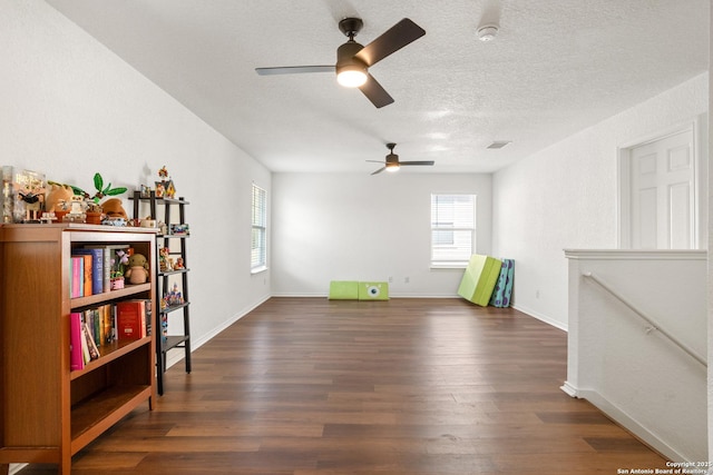 9311 Longmire, San Antonio, TX 78245 - unfurnished room with dark wood-style flooring, a ceiling fan, a textured ceiling, and baseboards