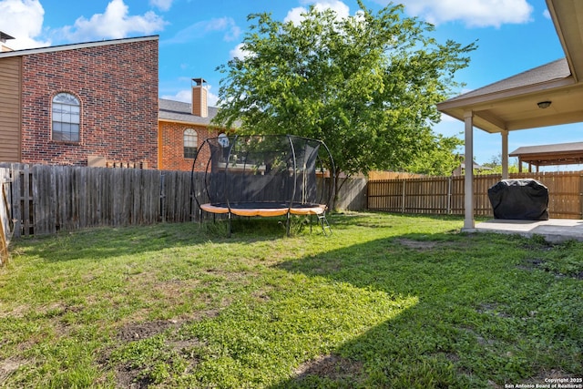 9311 Longmire, San Antonio, TX 78245 - view of yard with a trampoline and a patio