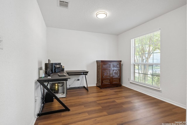9311 Longmire, San Antonio, TX 78245 - office space with plenty of natural light, wood finished floors, baseboards, and a textured ceiling