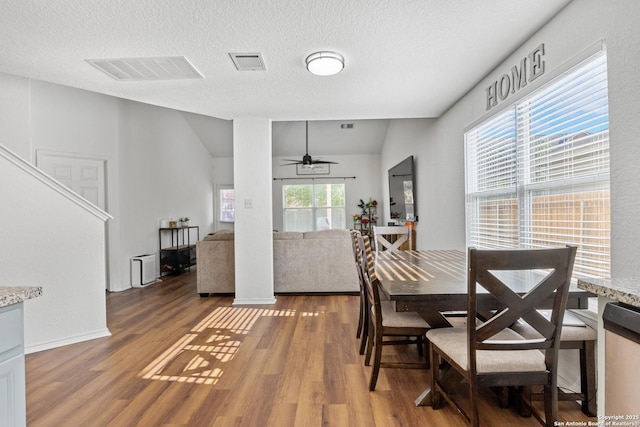 9311 Longmire, San Antonio, TX 78245 - dining room with wood finished floors, a ceiling fan, and a textured ceiling
