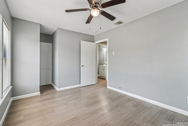 2415 Spicewood, San Antonio, TX 78213 - unfurnished bedroom featuring light wood finished floors, multiple windows, and baseboards