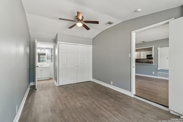 2415 Spicewood, San Antonio, TX 78213 - unfurnished bedroom with lofted ceiling, wood finished floors, a closet, baseboards, and connected bathroom