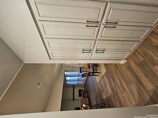 interior space featuring dark wood-type flooring and visible vents