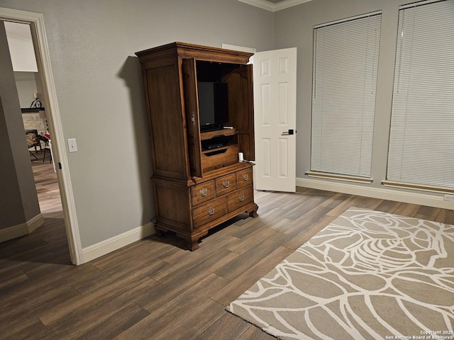 bedroom featuring baseboards and dark wood finished floors