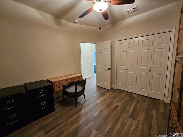 office with dark wood-style flooring, visible vents, baseboards, and a ceiling fan