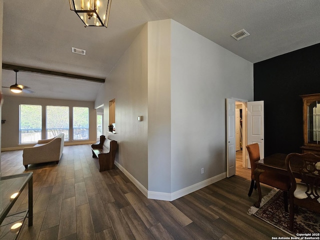 corridor featuring high vaulted ceiling, dark wood-style flooring, baseboards, and visible vents