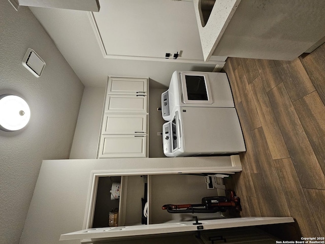 kitchen with a textured wall and wood finished floors