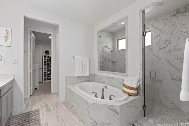 bathroom featuring a bath, a marble finish shower, a spacious closet, marble finish floor, and vanity