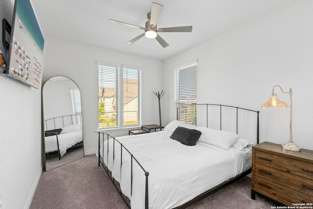 carpeted bedroom featuring baseboards and a ceiling fan