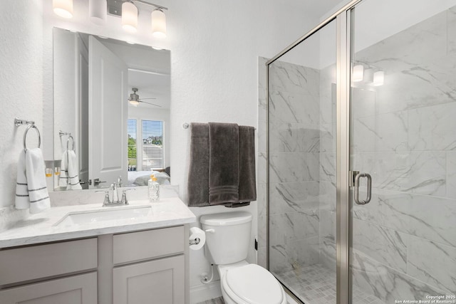 full bath featuring a shower stall, toilet, vanity, ceiling fan, and ensuite bathroom