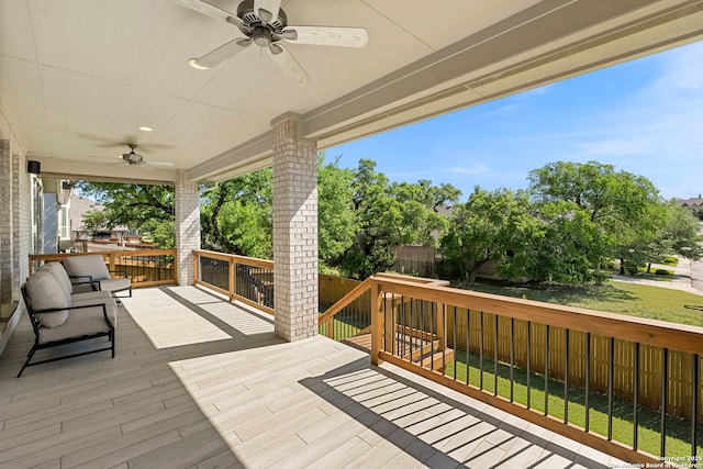 deck featuring a ceiling fan and a fenced backyard