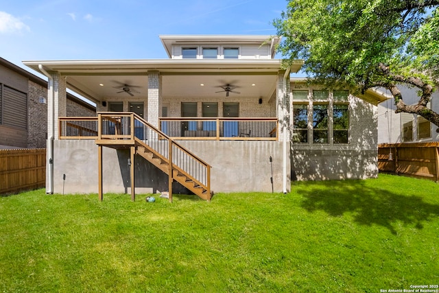 back of property featuring a fenced backyard, stairway, a yard, and ceiling fan