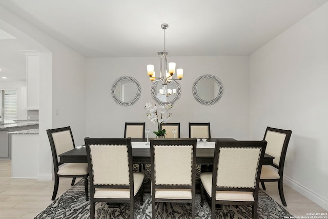 dining area featuring a chandelier, light wood finished floors, baseboards, and recessed lighting