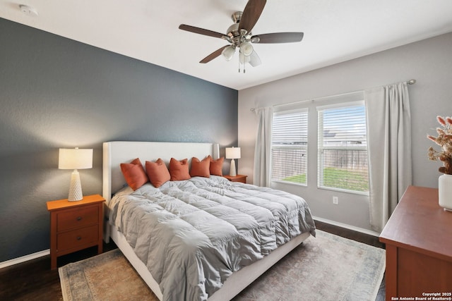 bedroom with dark wood-style flooring, baseboards, and ceiling fan
