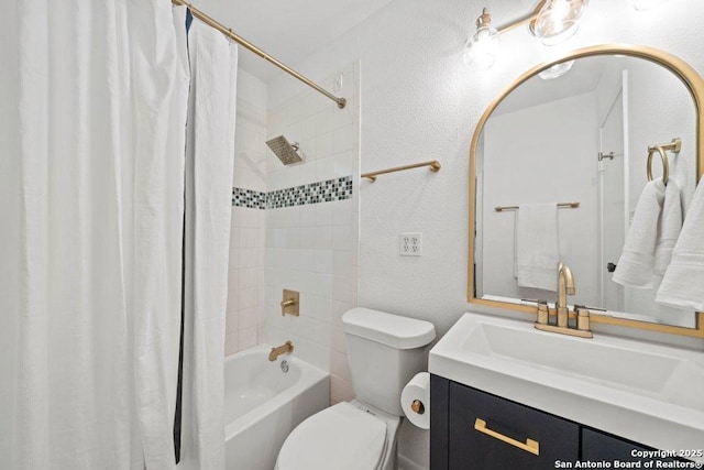 bathroom featuring toilet, shower / bath combo, a textured wall, and vanity