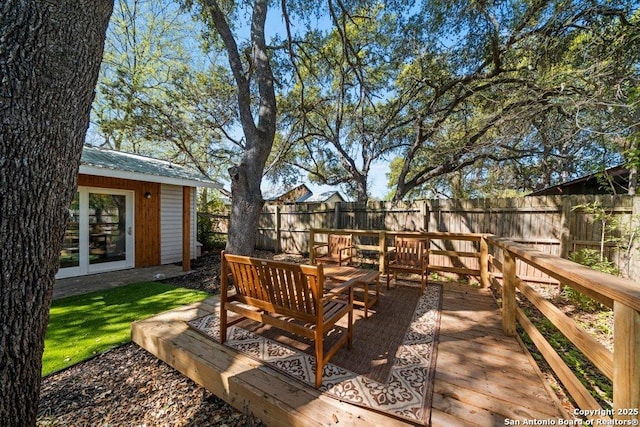 wooden terrace featuring a fenced backyard