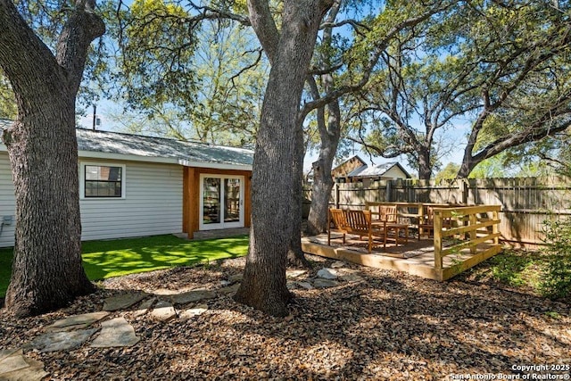 view of yard with a wooden deck and fence