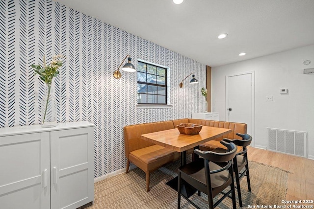 dining room featuring visible vents, baseboards, recessed lighting, and wallpapered walls